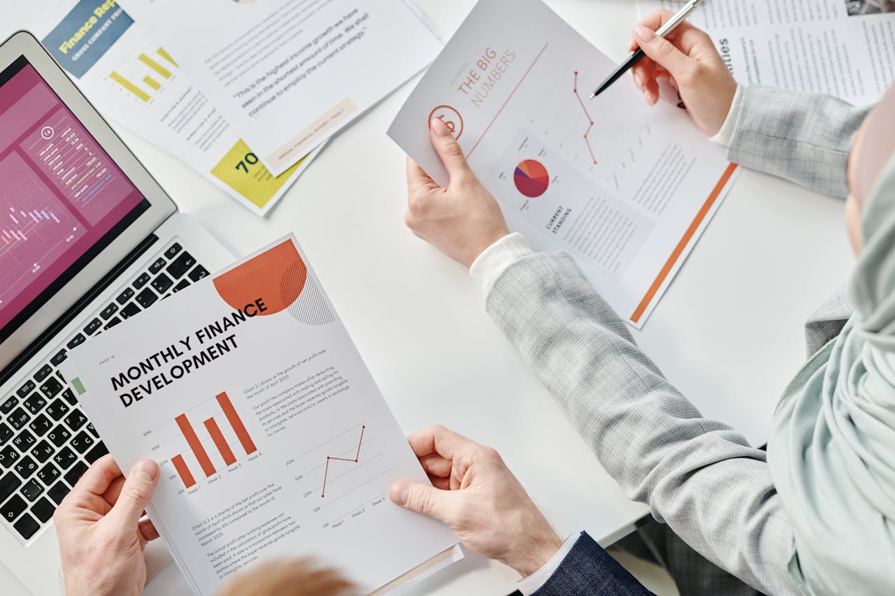 Services Top view of business colleagues analyzing financial reports during a meeting at the office.